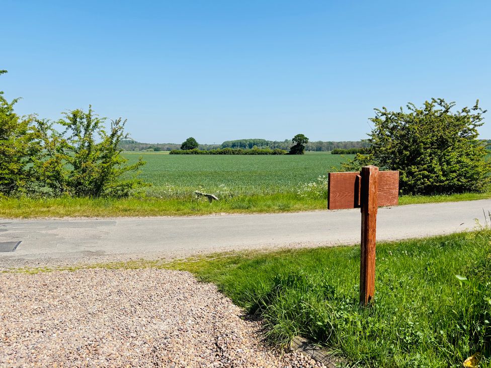 A view of a field and mailbox by the road at The Old Gate House Annexe in Alford
