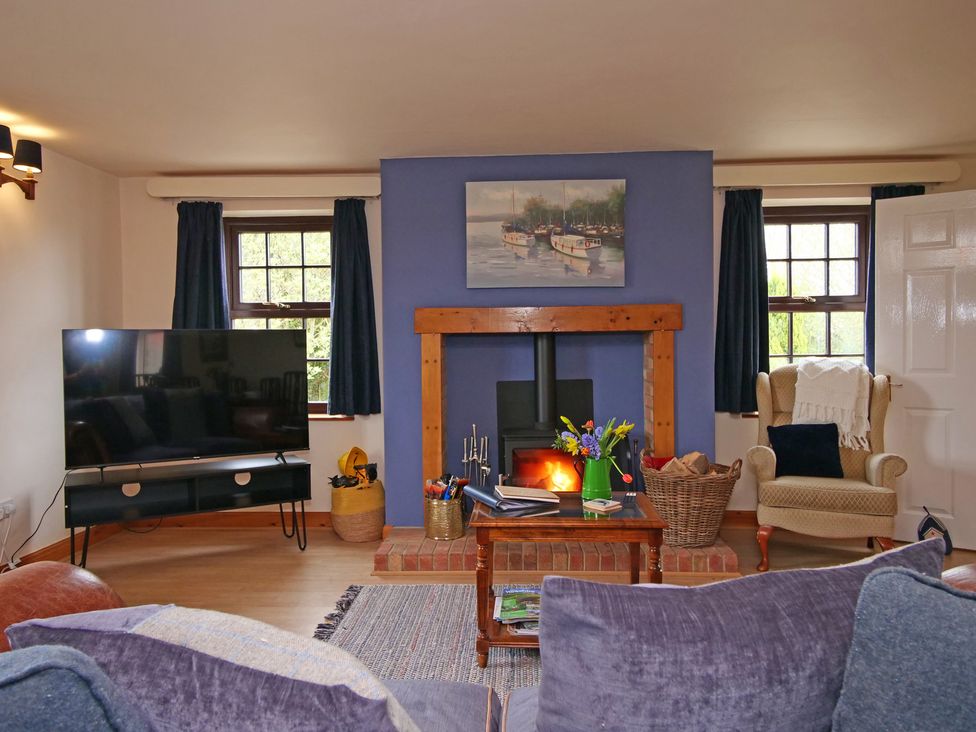 A living room with a television and fireplace at Albany @ Summerfield Farm in Hawsker