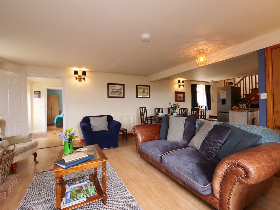A living room with a sofa, armchair, and coffee table at Albany @ Summerfield Farm, Hawsker
