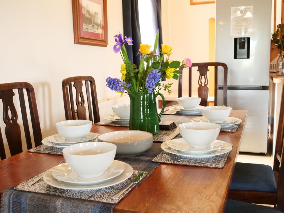 A dining table set with bowls and vases at Albany @ Summerfield Farm in Hawsker