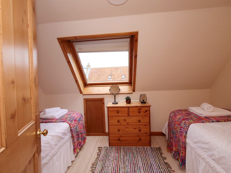 A bedroom with two beds and a dresser at Albany @ Summerfield Farm in Hawsker