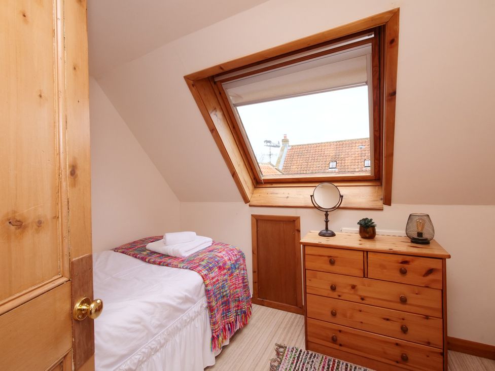 A bedroom with a bed and dresser at Albany @ Summerfield Farm, Hawsker
