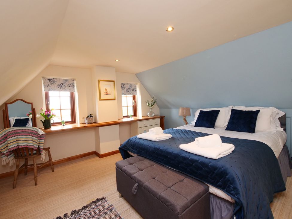 A bedroom with a bed and vanity mirror at Albany @ Summerfield Farm in Hawsker