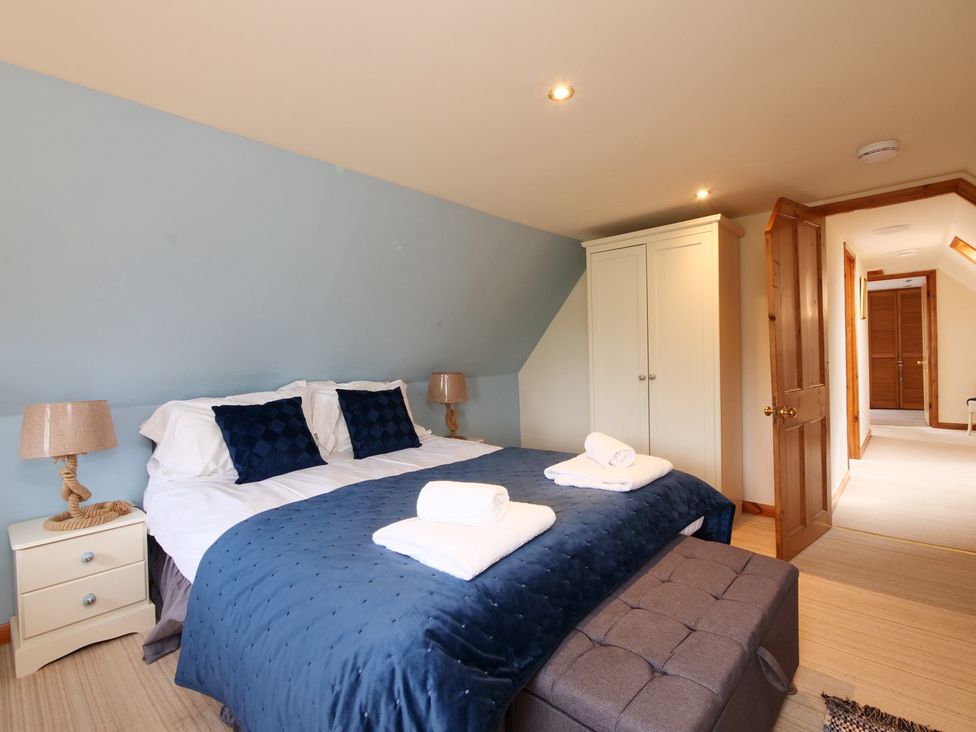 A bedroom with a bed and wardrobe at Albany @ Summerfield Farm in Hawsker