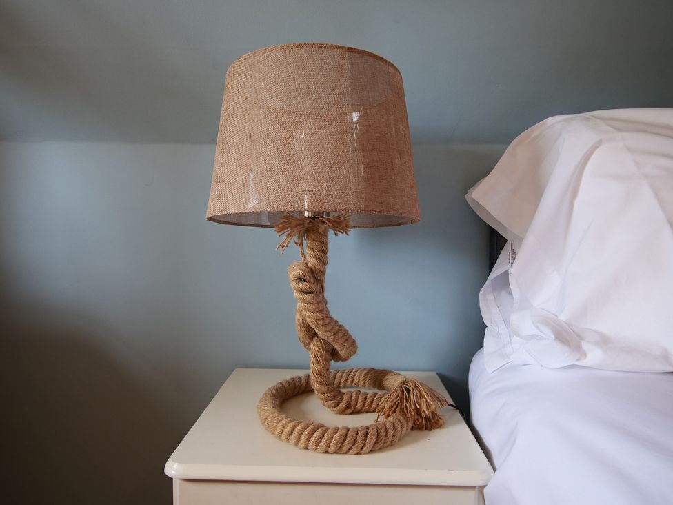 A lamp shaped like a rope on a bedside table at Albany @ Summerfield Farm in Hawsker