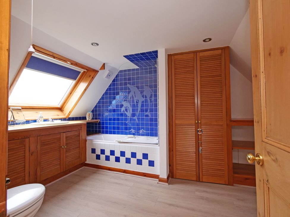 A bathroom with a bathtub and sink at Albany @ Summerfield Farm in Hawsker