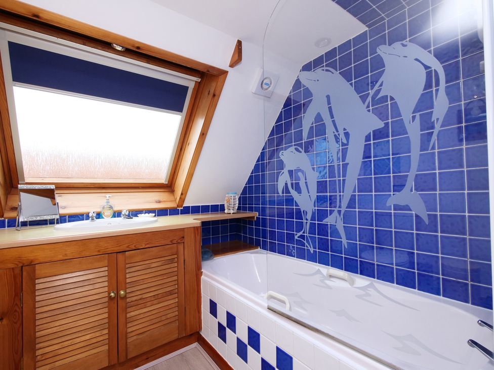 A bathroom with a bathtub and a sink at Albany @ Summerfield Farm in Hawsker