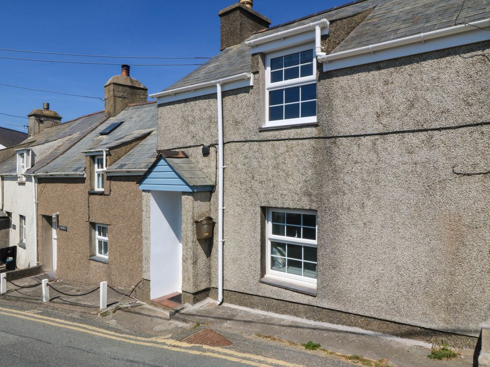 An exterior view of a house with windows and a door at 4 Bryn Llan Aberdaron