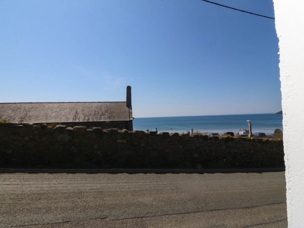 A view of the sea and beach from a building at 4 Bryn Llan in Aberdaron
