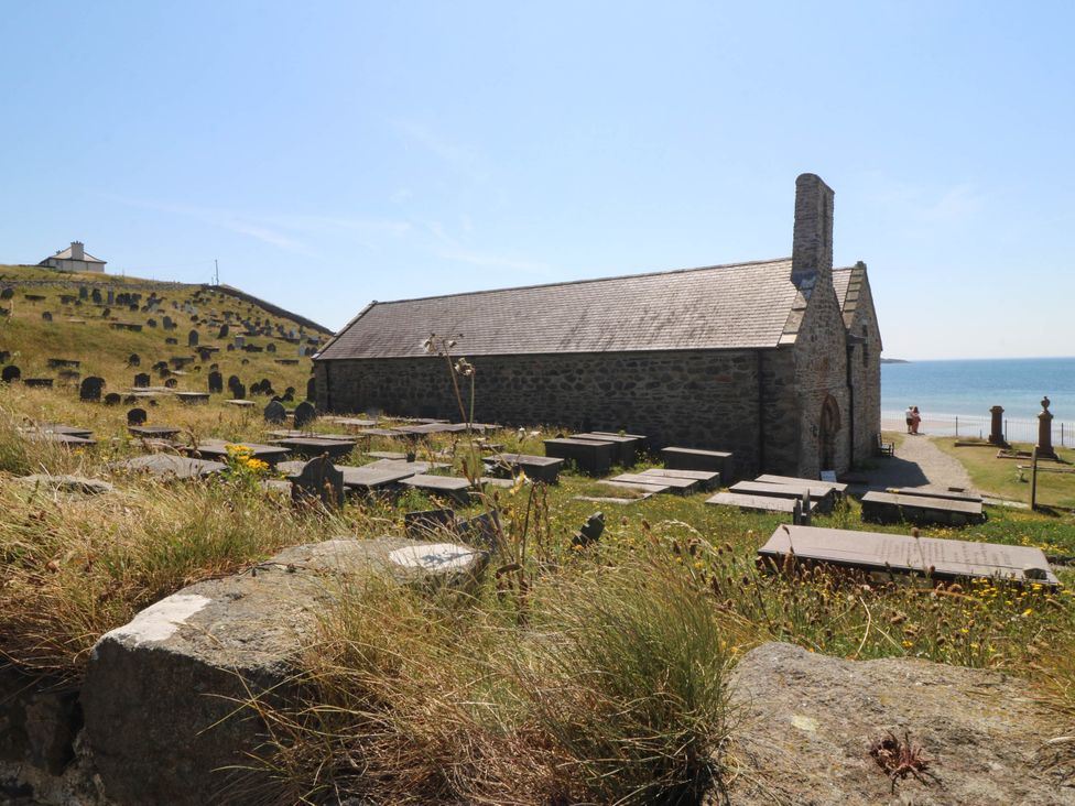 A church near a graveyard by the sea at 4 Bryn Llan in Aberdaron