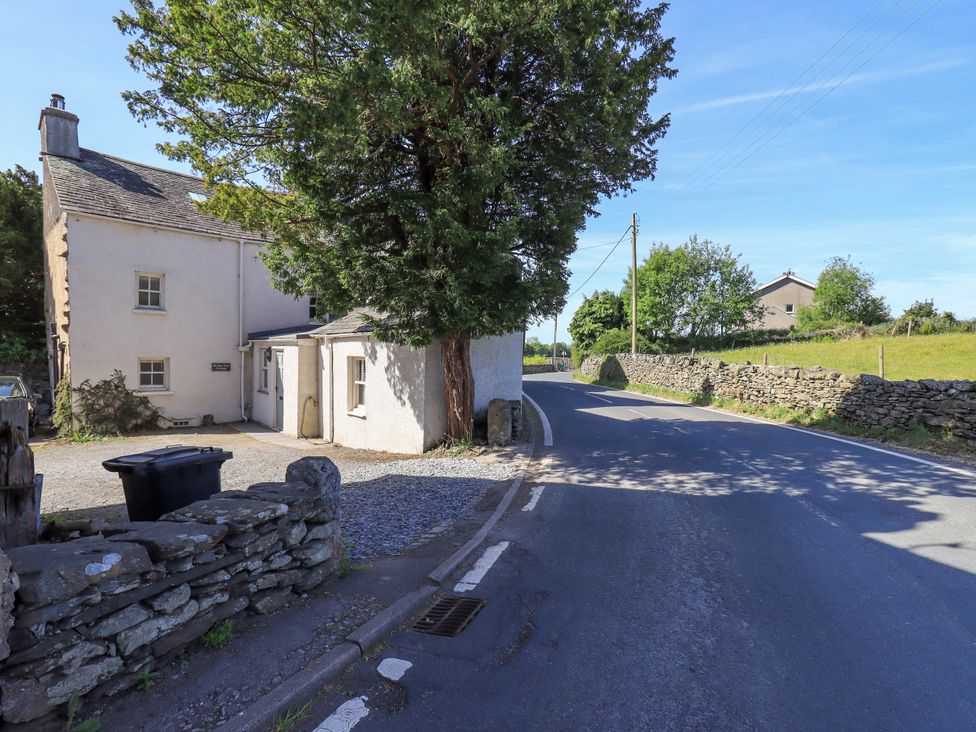 A house and garage near a road at Bridge End Cottage in Haverthwaite near Cartmel
