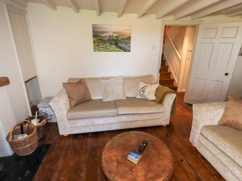 A living room with a sofa and a table at Bridge End Cottage Haverthwaite near Cartmel