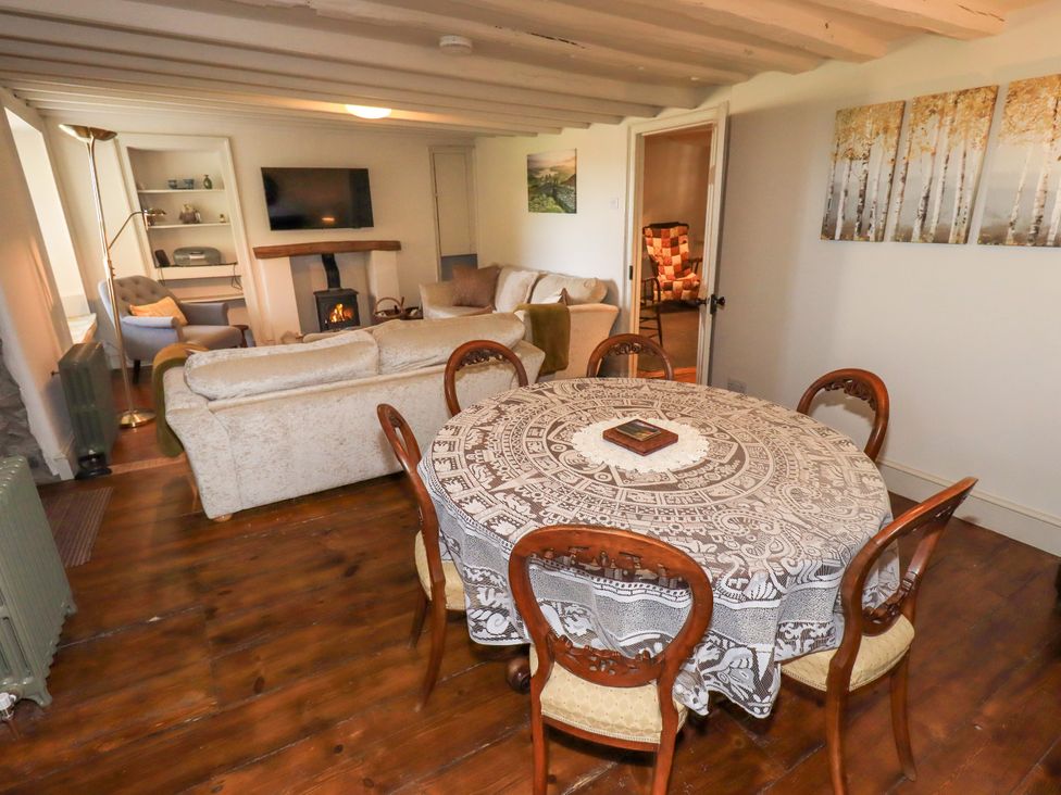 A dining room with a table and chairs at Bridge End Cottage Haverthwaite near Cartmel