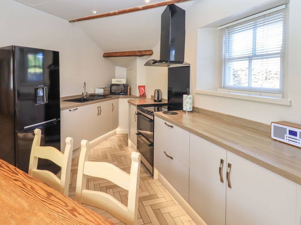 A kitchen with appliances and cabinetry at Bridge End Cottage in Haverthwaite near Cartmel