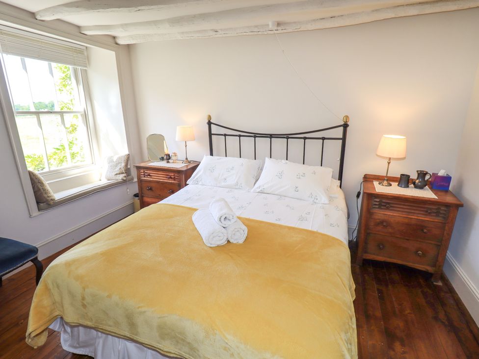 A bedroom with a double bed and bedside tables at Bridge End Cottage Haverthwaite near Cartmel