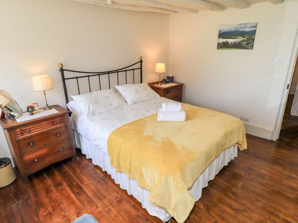 A bedroom with a bed and bedside tables at Bridge End Cottage in Haverthwaite near Cartmel