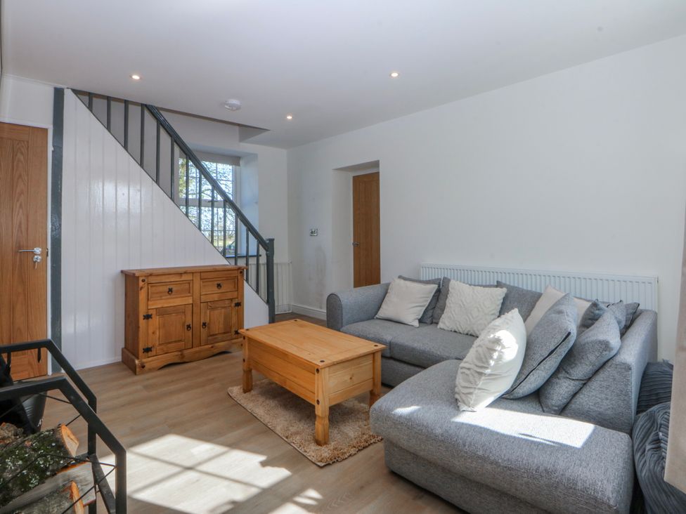 A living room with a sofa and coffee table at Gate House near Capel Coch