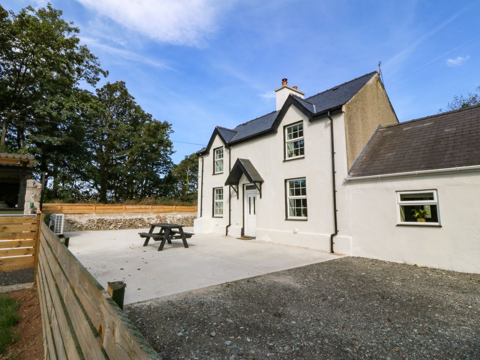 A house with a patio and table near Capel Coch near Llanerchymedd