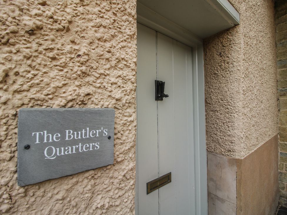 An entryway with a door and sign at The Butler’s Quarters in Bourton near Much Wenlock