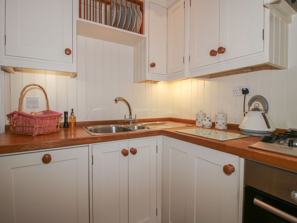 A kitchen with a sink and cabinets at The Butler’s Quarters in Bourton near Much Wenlock