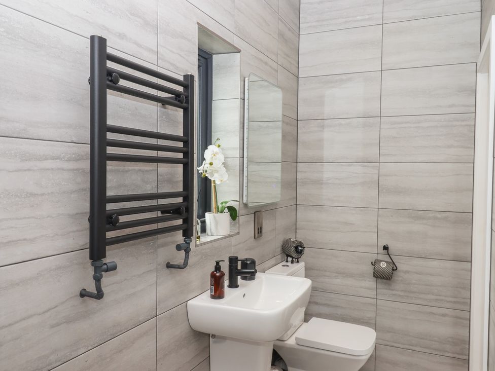 A bathroom with a towel radiator and sink at The Cadeleigh in Cadeleigh near Tiverton