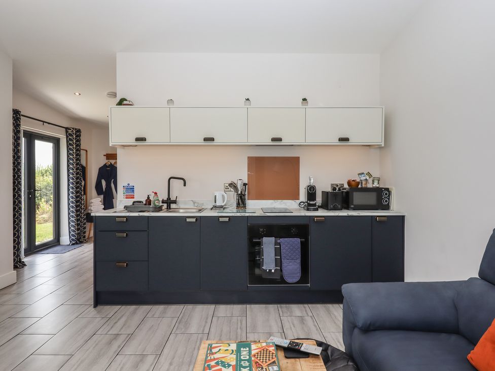A kitchen with cabinets and appliances at The Cadeleigh Cadeleigh near Tiverton
