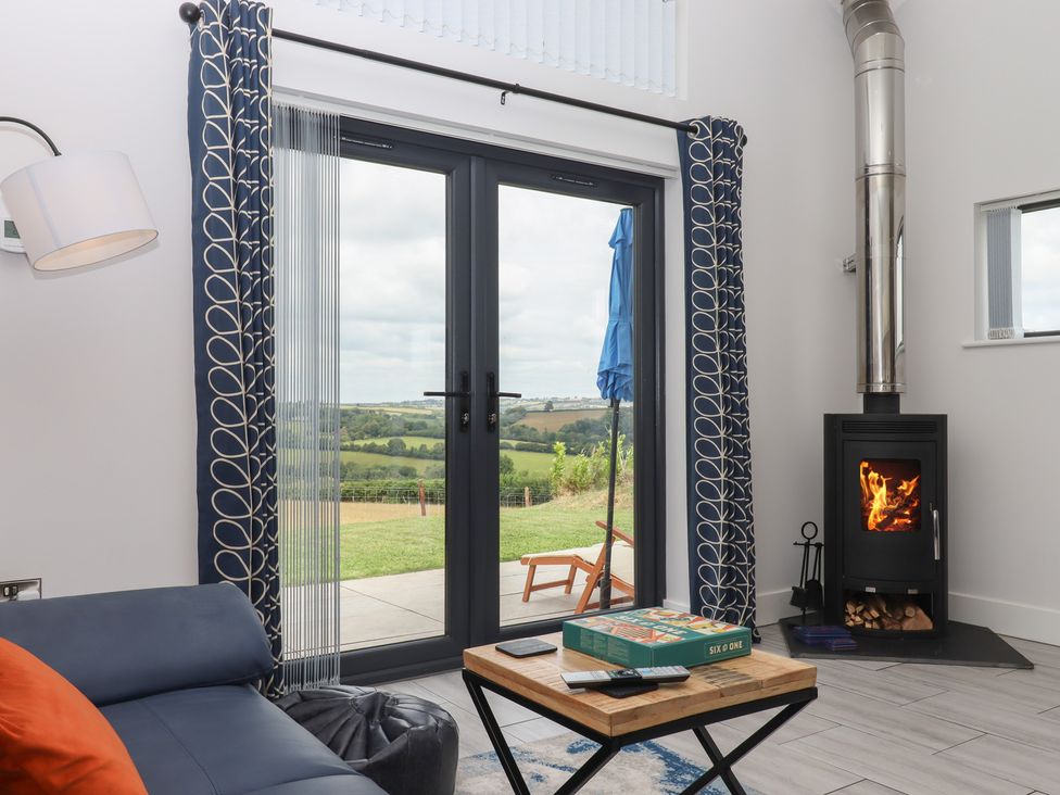 A living room with a stove and coffee table at The Cadeleigh near Tiverton