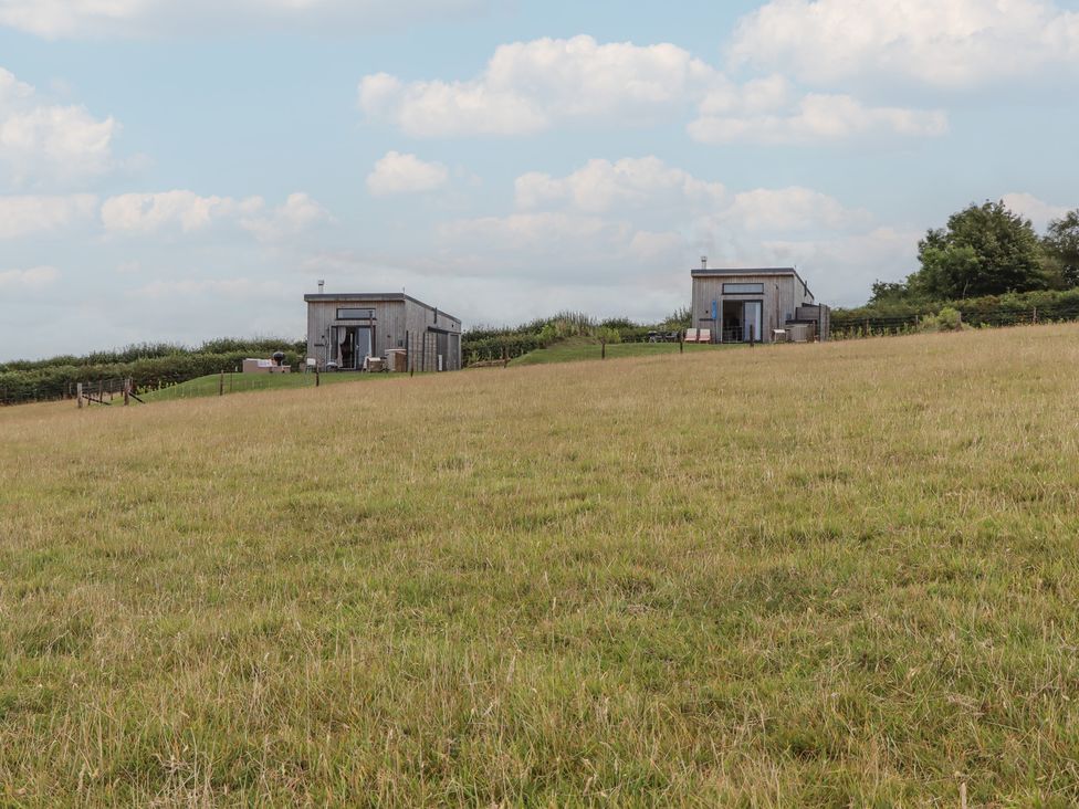 Two buildings on a grassy field at The Cadeleigh in Cadeleigh near Tiverton