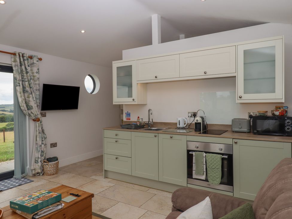 A kitchen with cabinets and appliances at The Pennymoor in Cadeleigh near Tiverton