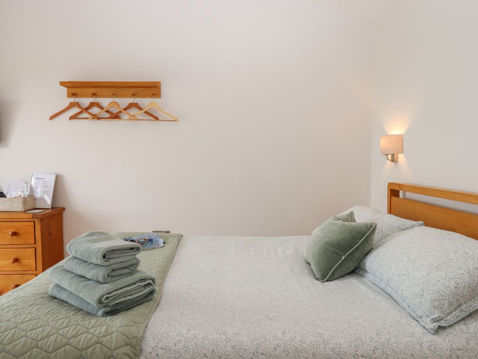 A bedroom with a bed and towels on top at The Pennymoor in Cadeleigh near Tiverton