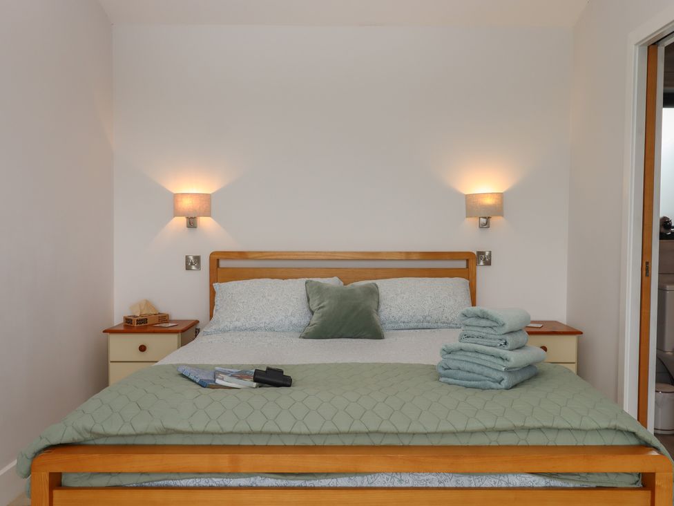 A bedroom with a bed and towels at The Pennymoor in Cadeleigh near Tiverton