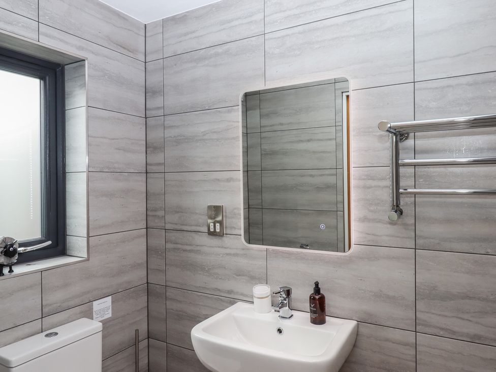 A bathroom with a sink and a mirror at The Pennymoor in Cadeleigh near Tiverton