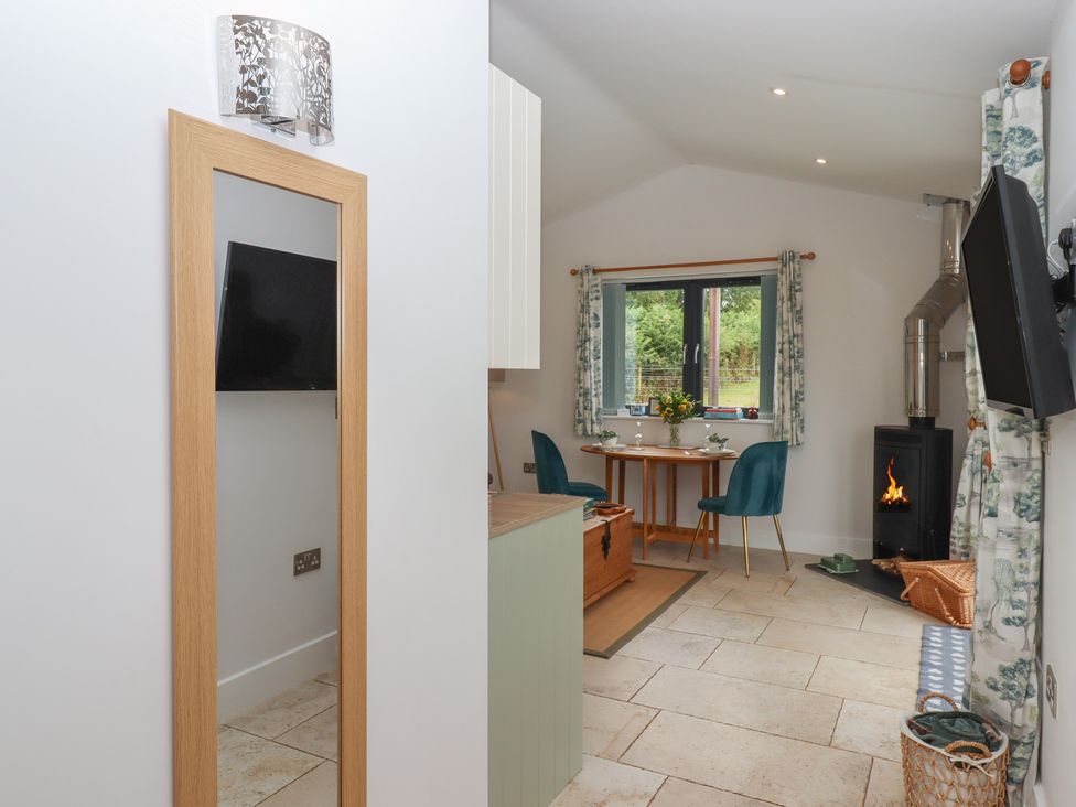 A living room with a table and chairs at The Pennymoor in Cadeleigh near Tiverton