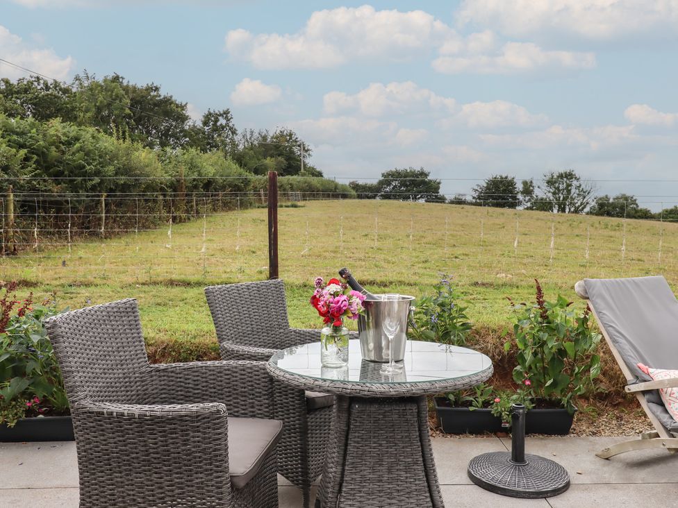 A seating area with a table and chairs at The Pennymoor in Cadeleigh near Tiverton