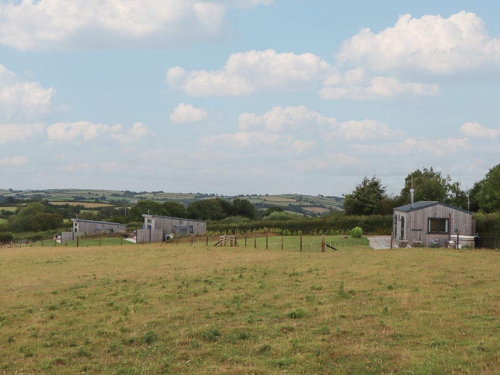 A view of several houses on grassland at The Pennymoor in Cadeleigh near Tiverton