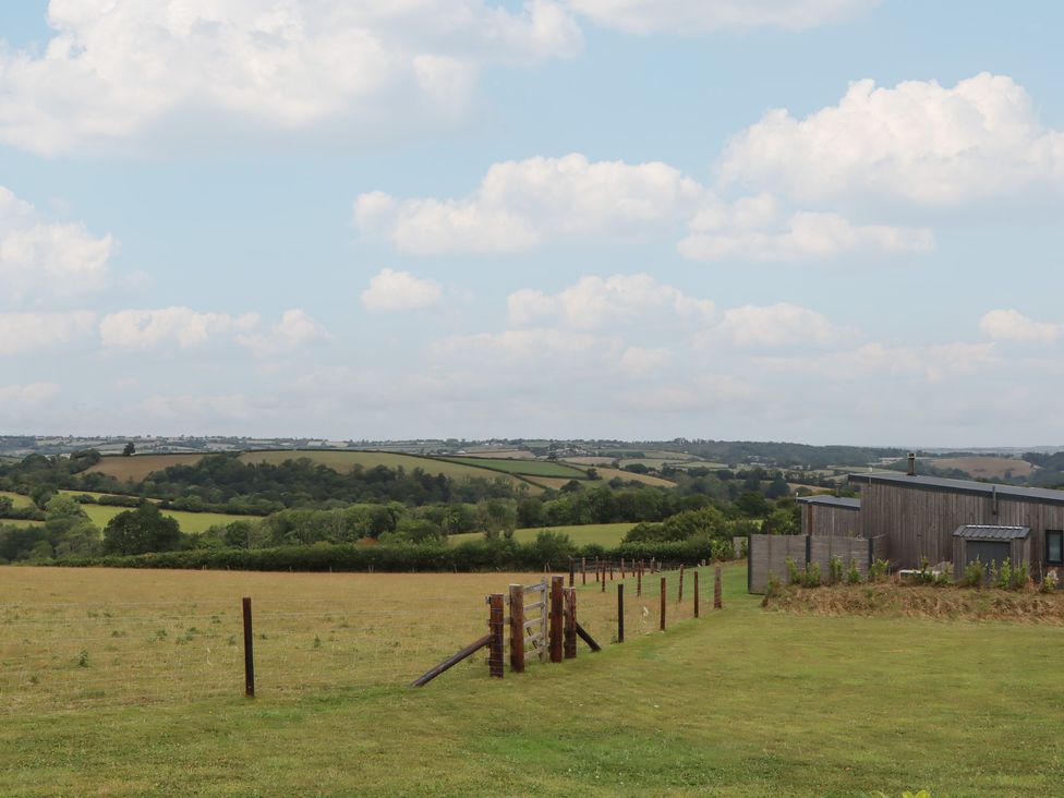 An outdoor area with grass and a building at The Pennymoor in Cadeleigh near Tiverton