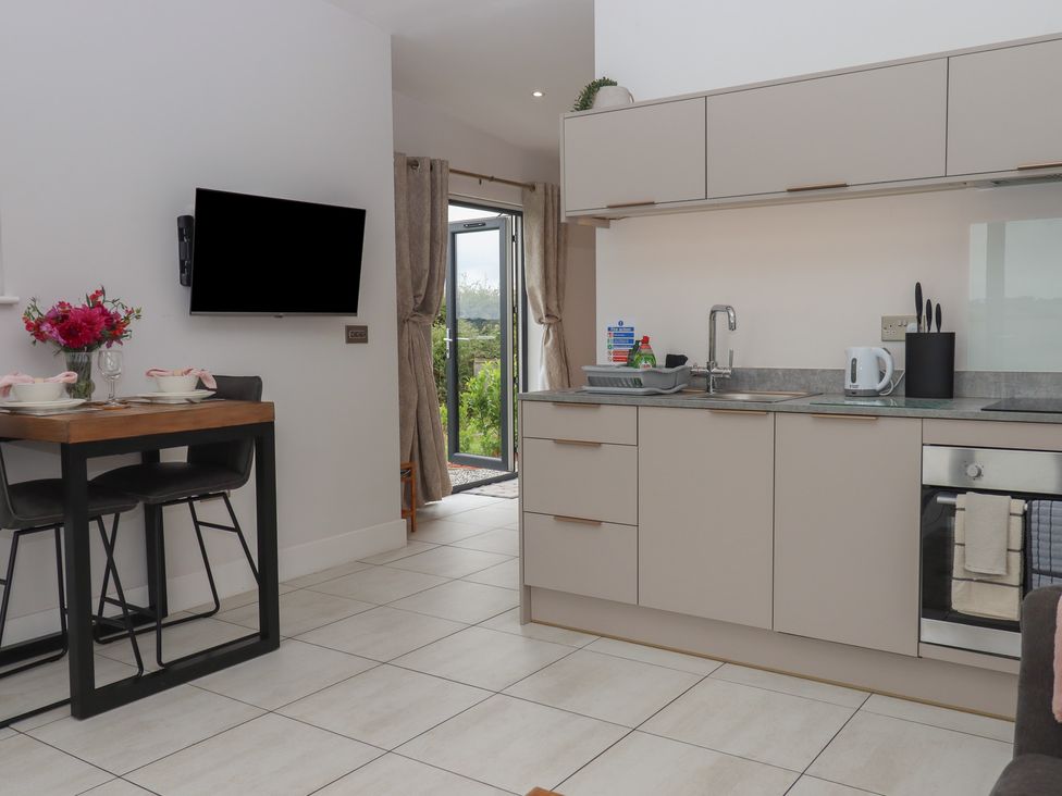 A kitchen with a dining table and chairs at The Bickleigh in Cadeleigh near Tiverton