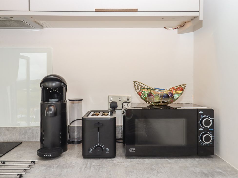 A kitchen with coffee machine toaster microwave and fruit bowl at The Bickleigh Cadeleigh near Tiverton