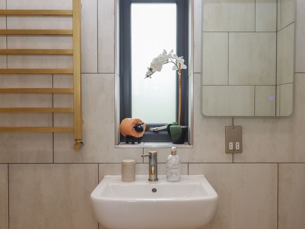 A bathroom with a sink and mirror at The Bickleigh near Tiverton