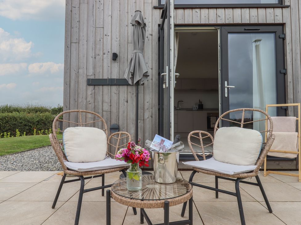 An outdoor seating area with chairs and a table at The Bickleigh Cadeleigh near Tiverton