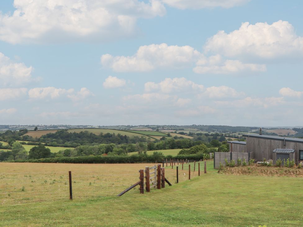 A field with a fence and building at The Bickleigh in Cadeleigh near Tiverton