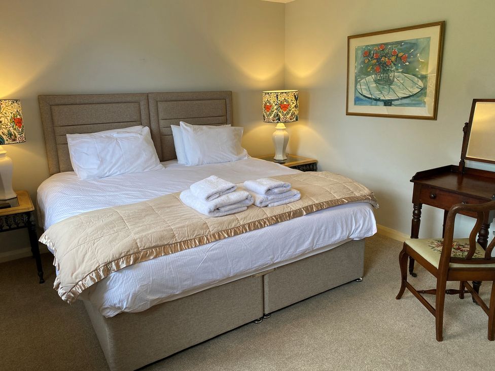 A bedroom with a bed and side tables at Greywalls in Maulds Meaburn