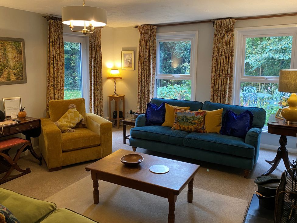 A living room with sofa and armchair at Greywalls in Maulds Meaburn