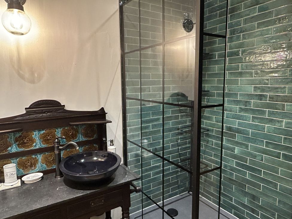 A bathroom with a sink and shower at The Salt Pot in Oakworth