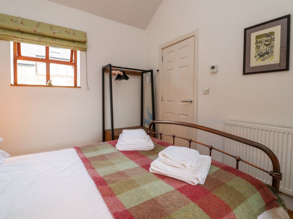 A bedroom with a bed and wardrobe at The Stables Hall Green near Walmer Bridge