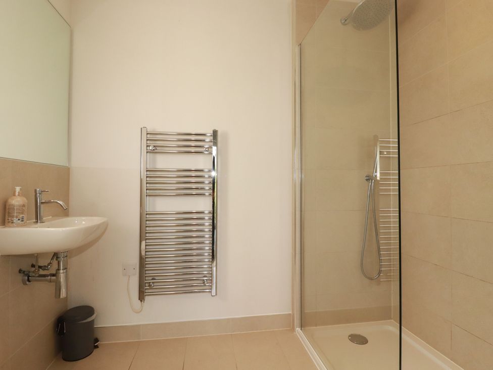 A bathroom with a shower and wash basin at Chi Gwynn in Crantock