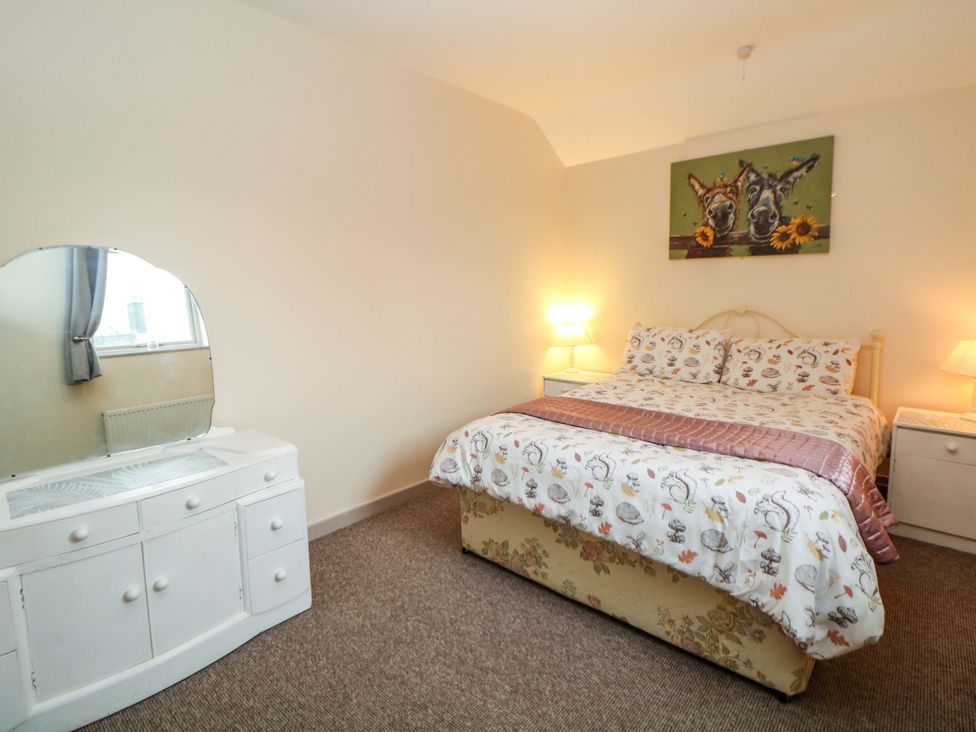 A bedroom with a bed and dressing table at Ford Coach House Cottage in Ford near Leek