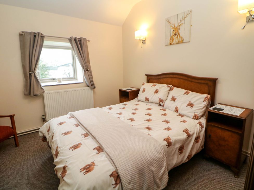 A bedroom with a bed and a window at Ford Coach House Cottage Ford near Leek
