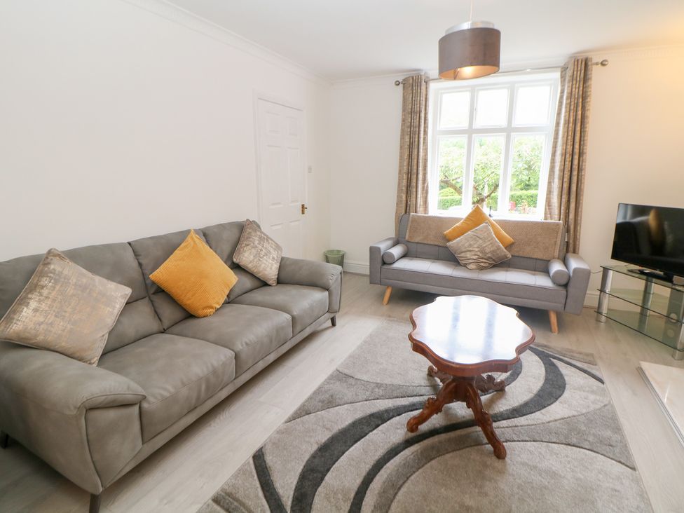 A living room with sofas and a coffee table at 15 Calton View in Bakewell
