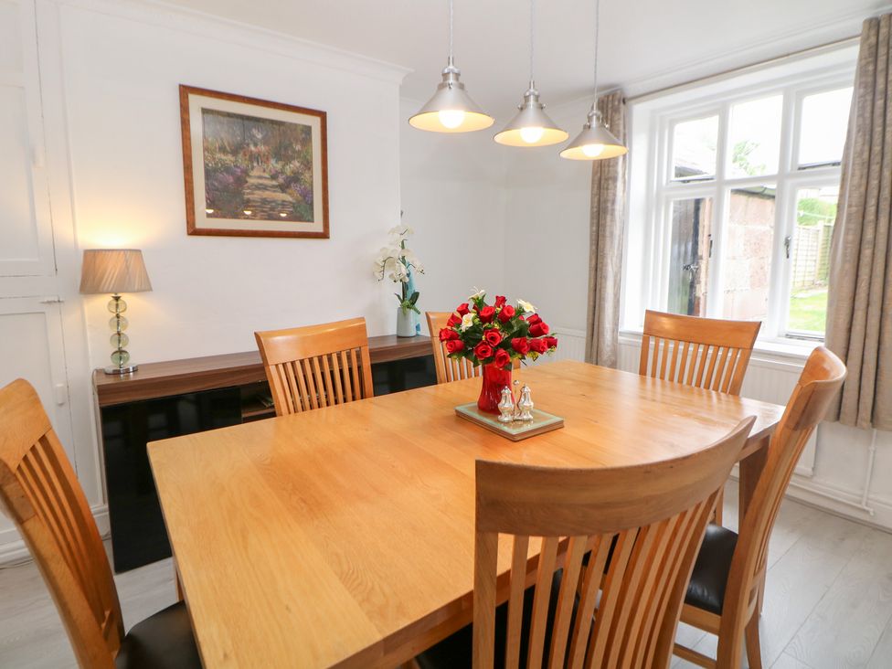 A dining room with a table and chairs at 15 Calton View Bakewell